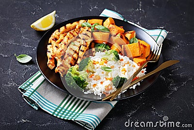 Close-up of chicken strips, broccoli, rice, yams Stock Photo