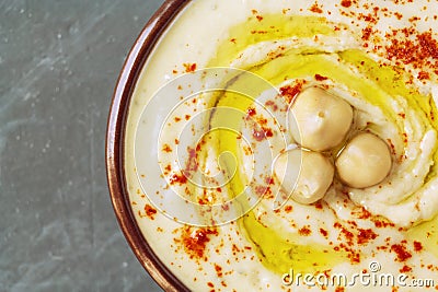 Close up of chickpea hummus decorated with boiled chickpeas, olive oil and paprika. Stock Photo