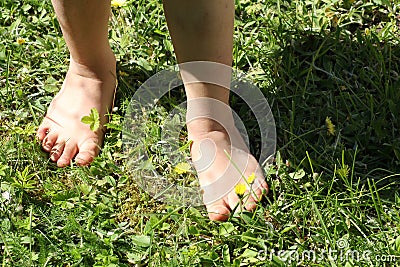 Close-up of a child barefoot on the lawn - a symbol of ecology Stock Photo