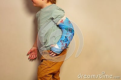 Close-up of a child broken hand in plaster with kids drawings Stock Photo