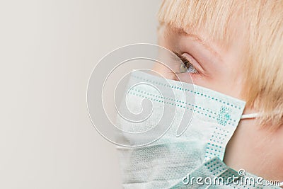 Close up of child face in surgical mask, white background. Prevention of bacterial infection Covid 19 Stock Photo