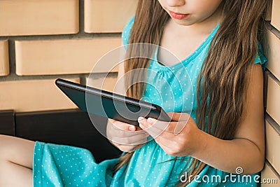 Child looking at tablet. Concept of online communication, daily pleasures Stock Photo