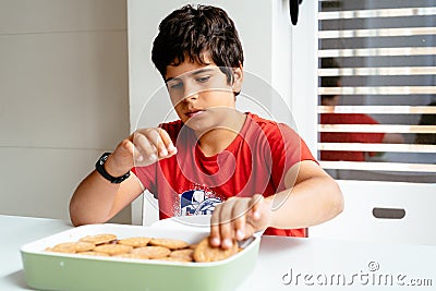 Close up of child preparing homemade chocolate cake Stock Photo