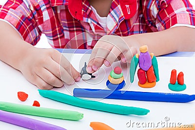 Close up child's hand moulding modeling clay. Strengthen the ima Stock Photo