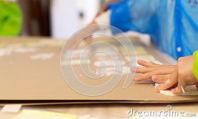 Close-up of a children in art therapy class drawing, painting and practicing engraving art. Child education in primary school at Stock Photo