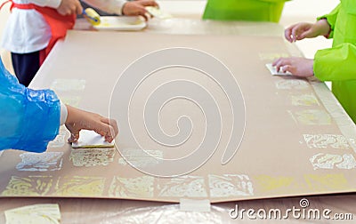 Close-up of a children in art therapy class drawing, painting and practicing engraving art. Child education in primary school at Stock Photo