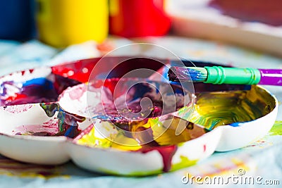 Close-up of childrens paint brush on paint palette Stock Photo