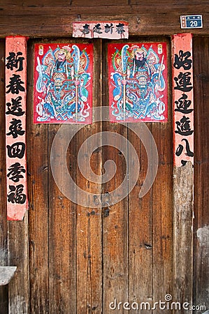 Close up of chinese doors with posters of gods to protect from the demons Editorial Stock Photo