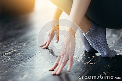 Close up. Chinese girl is engaged in stretching feet. Sports training at home Stock Photo