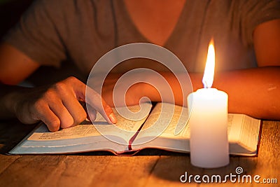 Close up of Christian boys are reading and study bible In the room and lit candles to light, Religious concepts Stock Photo