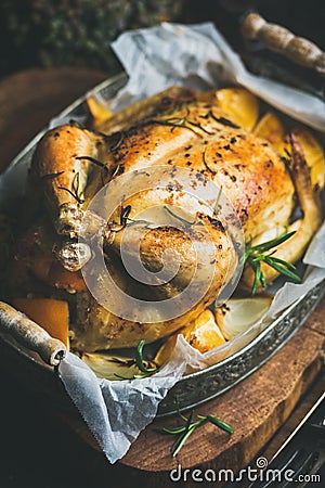 Close-up of Christmas roasted whole chicken with rosemary, bulgur, oranges Stock Photo