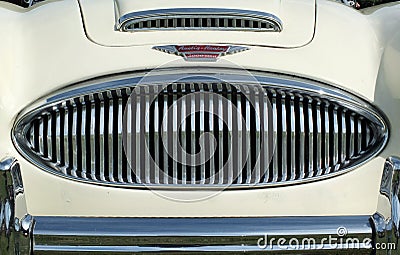 Close up of the chrome grill bumper and badge of a vintage white austin healey 300 classic sports car at hebden bridge vintage wee Editorial Stock Photo