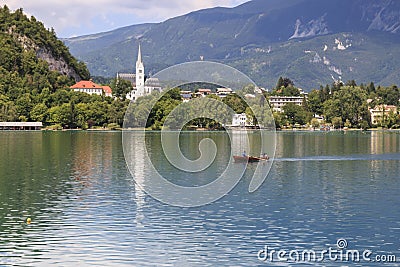 Close up of the church in the center of Bled Lake with a small boat on foreground Editorial Stock Photo