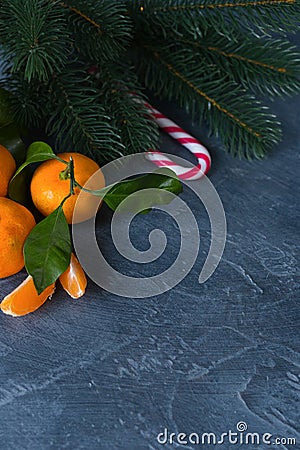 Close-up citrus. Bright ripe tangerines with green leaves on dar Stock Photo