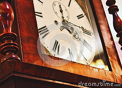 Close up of clock face on an antique grandfather clock with roman numerals Stock Photo
