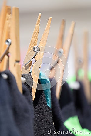 Close up of clothing pegs holding washing on the washline. Stock Photo