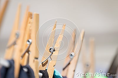 Close up of clothing pegs holding washing on the washline. Stock Photo