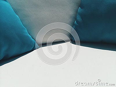 Close up coach with blue and white pillows outside at cafe terrace at sunny day Stock Photo