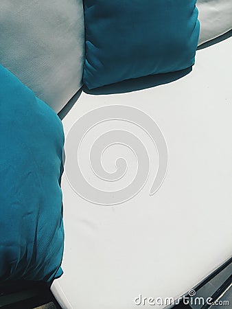 Close up coach with blue and white pillows outside at cafe terrace at sunny day Stock Photo