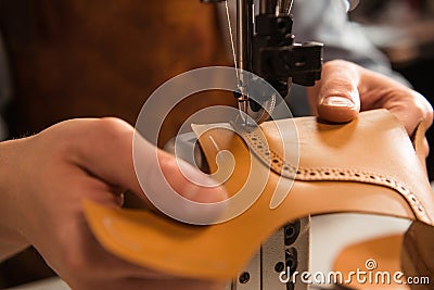 Close up of a cobbler stitching a part of shoe Stock Photo