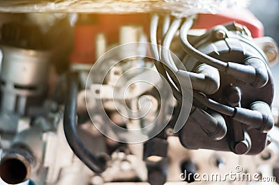 Close up coil distributor wire four cylinder engine stand on car with sunlight Stock Photo