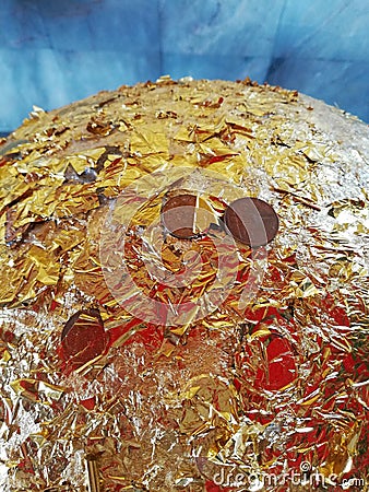 Close up of coins and gold leaf on the sacred marker sphere, Luuk Nimit Stock Photo