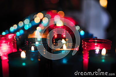Close up of colorful candles in a dark spiritual scene. Commemoration, funeral, memorial. Religious symbolism Stock Photo