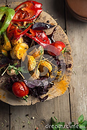 Close Up of Colorful Grilled Vegetable Bounty Tray on Wooden Pan copyspace Stock Photo