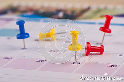 Sticky paper and thumbtacks on calendar for planning concept background Stock Photo