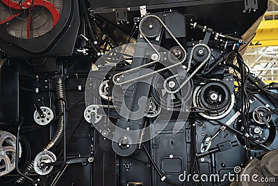 Close-up of combine harvester mechanisms with iron chains, power units and hydraulic systems. Agricultural machinery in Stock Photo