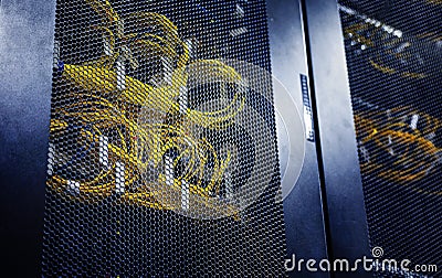 Close up connected yellow optical cable in control modules heat power. Computer servers in big data centre. Network and Stock Photo