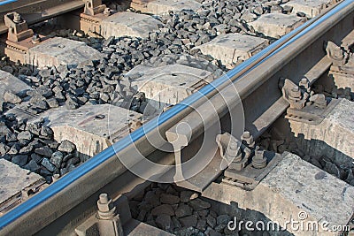 Close-up of the connection of railway rails, the rolled track from the trains is visible. Horizontal photo Stock Photo