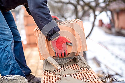 close-up of construction worker, bricklayer building new house with bricks Stock Photo