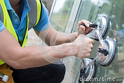 Close Up Of Construction Worker Preparing To Fit New Windows Stock Photo