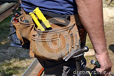 Close up of construction worker with tool belt Stock Photo