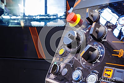 Close up of control panel of CNC machine with adjustment controls and push buttons. Selective focus. Stock Photo