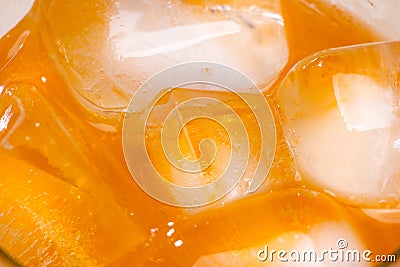 Close-up of cool glass of orange soda drink with ice Stock Photo