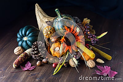 Close up of a cornucopia centrepiece filled with various autumn decorations Stock Photo