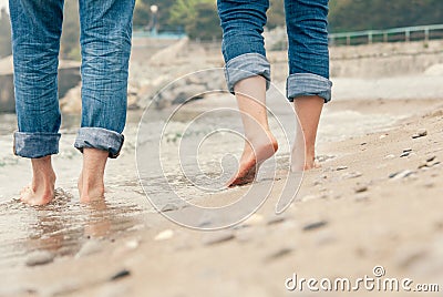 Close up couple legs image on the surf line Stock Photo