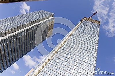 Close up of crane on top of high rise building Stock Photo