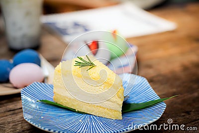 Close-up Cream cheese chiffon cake in a tiled plate decorated with rosemary leaves, Stock Photo