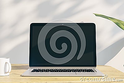 Close up of creative designer office desktop with empty laptop display with mock up place in frame, concrete wall background with Editorial Stock Photo