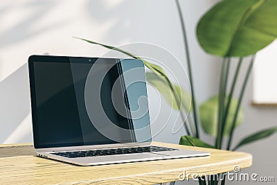 Close up of creative designer office desktop with empty laptop monitor with mock up place in frame, concrete wall background with Editorial Stock Photo