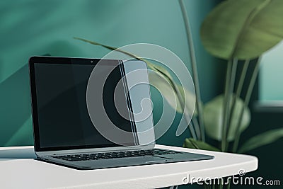 Close up of creative designer office desktop with empty laptop screen with mock up place in frame, green wall background with Editorial Stock Photo