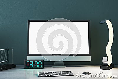 Close up of creative designer table with empty white mock up computer monitor, supplies and various items on blue concrete wall Editorial Stock Photo