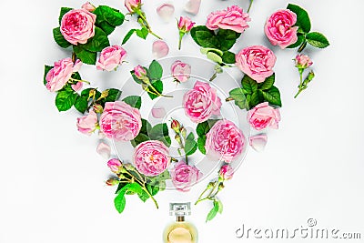 Close up creative layout with Perfume bottle and fly out pink tea rose flowers on white background isolated. Fresh concept with lu Stock Photo