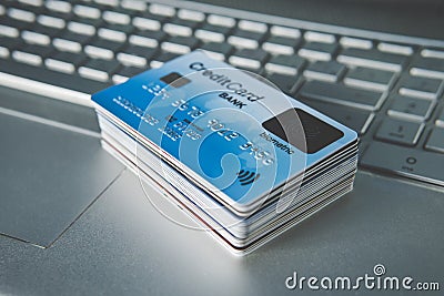 Close up of credit cards set in pile on laptop keyboard. E-commerce concept. Group of credit cards with biometric card on the top Stock Photo