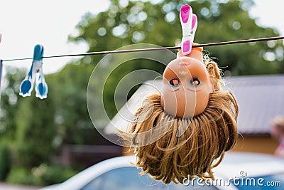 Photo of creepy doll hanging at barn Stock Photo