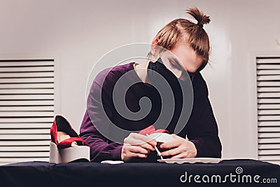 Close up cropped photo. man painting with a tip of the brush, focus on the cloth, leather. Stock Photo