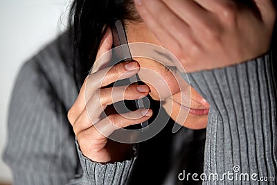 Close up of crying woman calling on smartphone Stock Photo